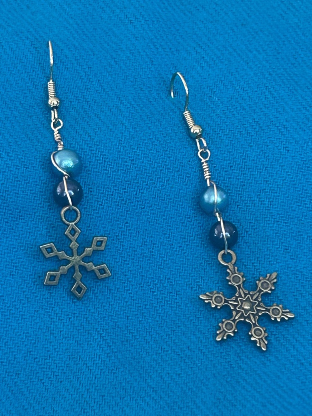 Blue Snowflake Drop Earrings with Brass-tone charms.